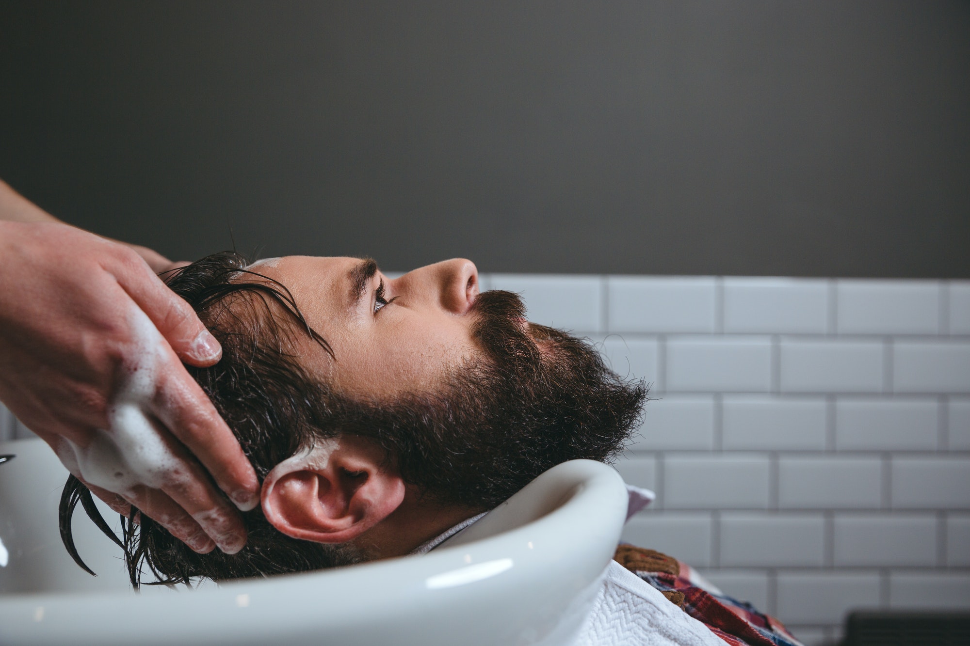 Barber washing client's hair